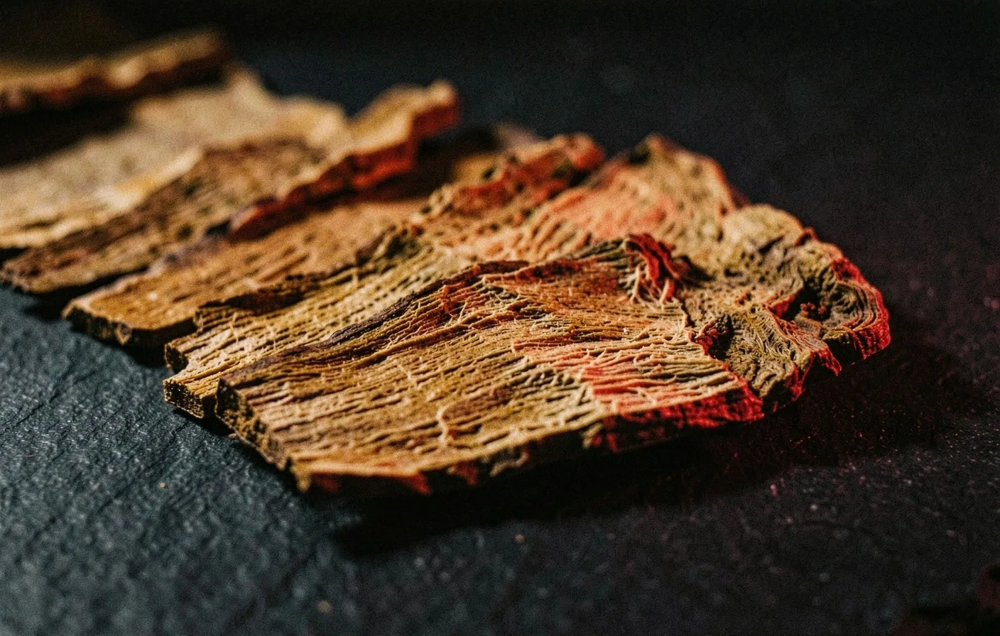 Macro photograph of dried ginseng root on dark surface